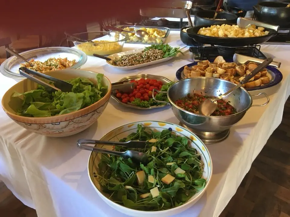 Mesa de buffet com saladas e acompanhamentos variados